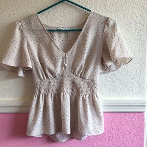 A cute polkadot two button blouse!